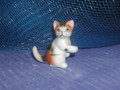 Miniature "Petit chat tricolore assis patte en l'air"