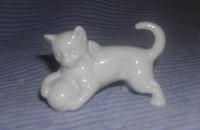 Chat blanc posant sa patte sur une balle